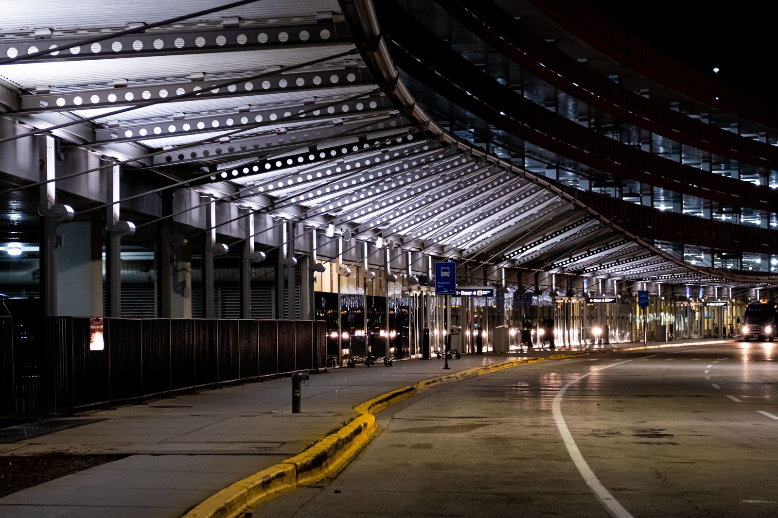 An airport terminal curb lit at night